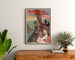 Poster Normandia vintage – Trouville, casinò municipale, incorniciato sopra una cassettiera in legno, tra delle piante.